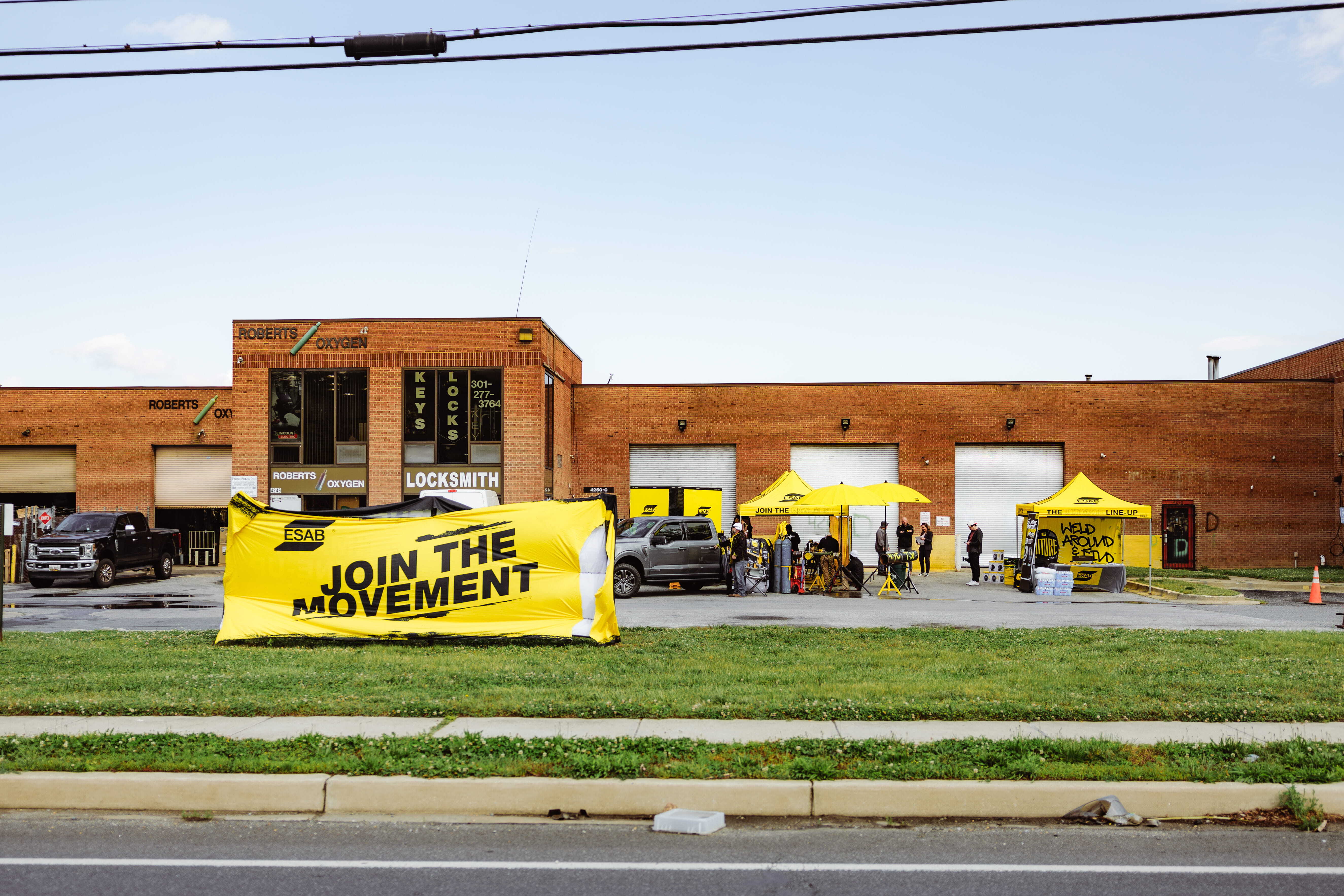 ESAB Demo Tour showcases live welding demos outside a brick building, with welders engaging in hands-on experiences.