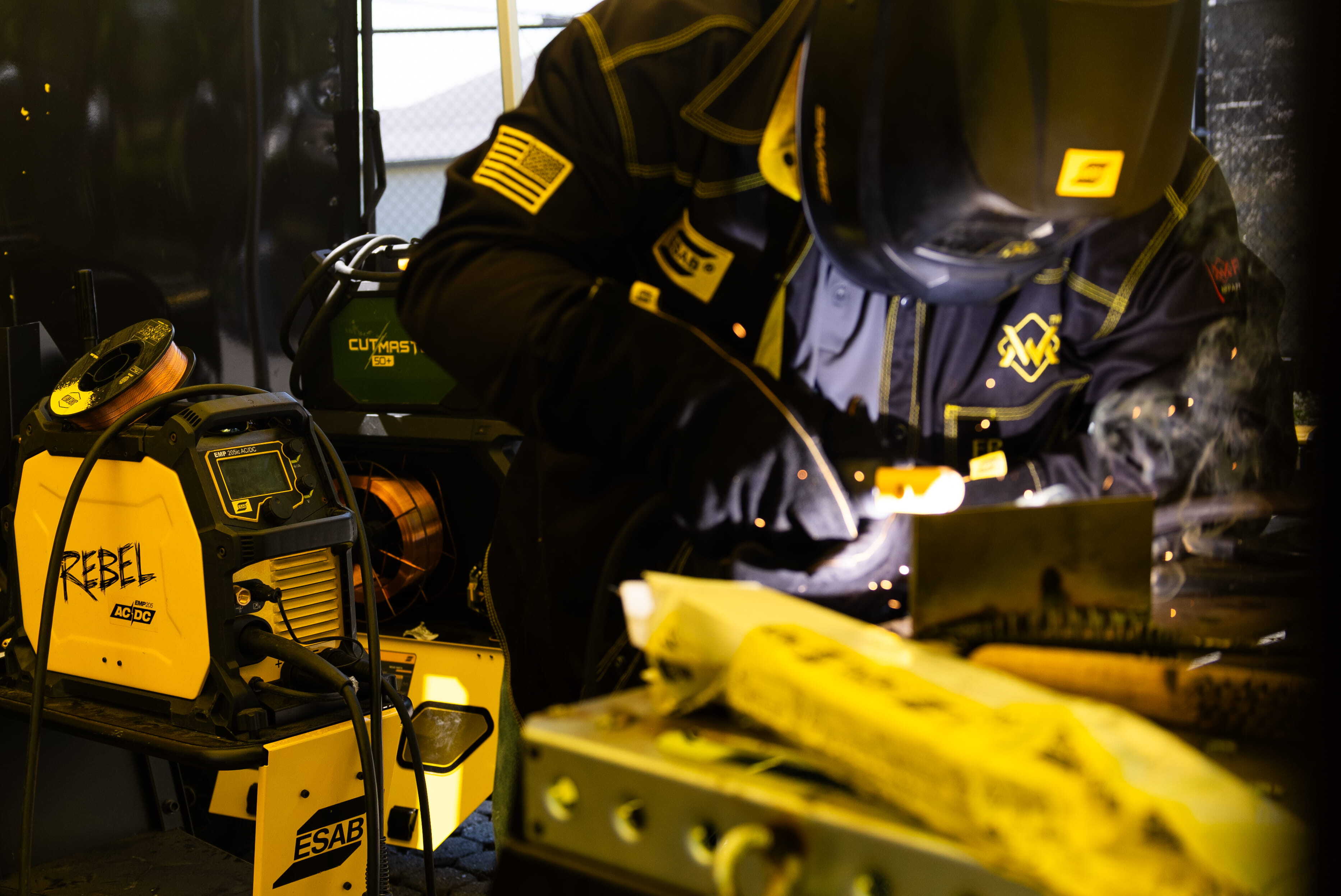Welder at ESAB Demo Tour showcasing live welding demos, sparks flying as they expertly handle equipment.