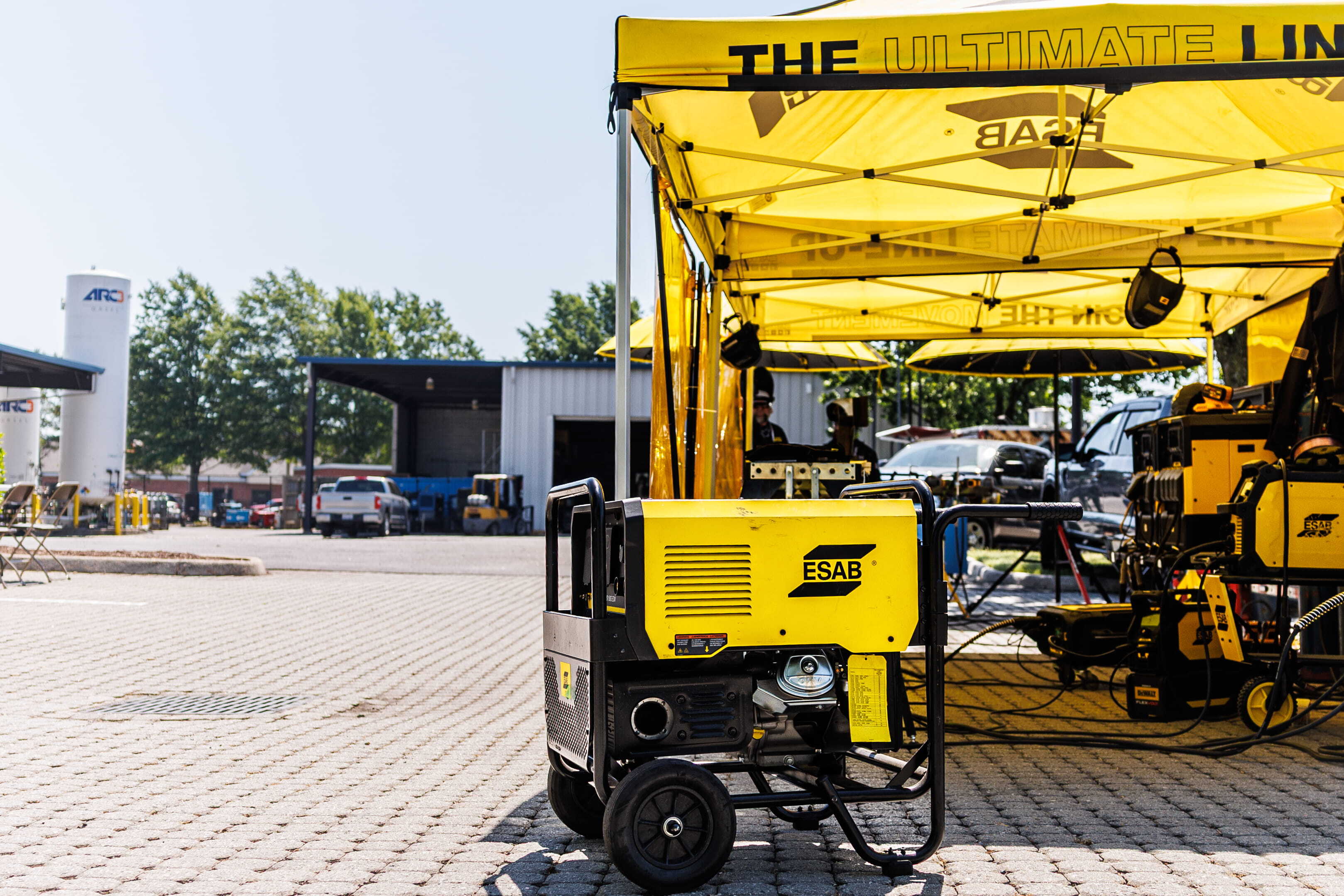 ESAB Demo Tour showcases live welding demos under a yellow tent, with welders and equipment set up for hands-on experience.