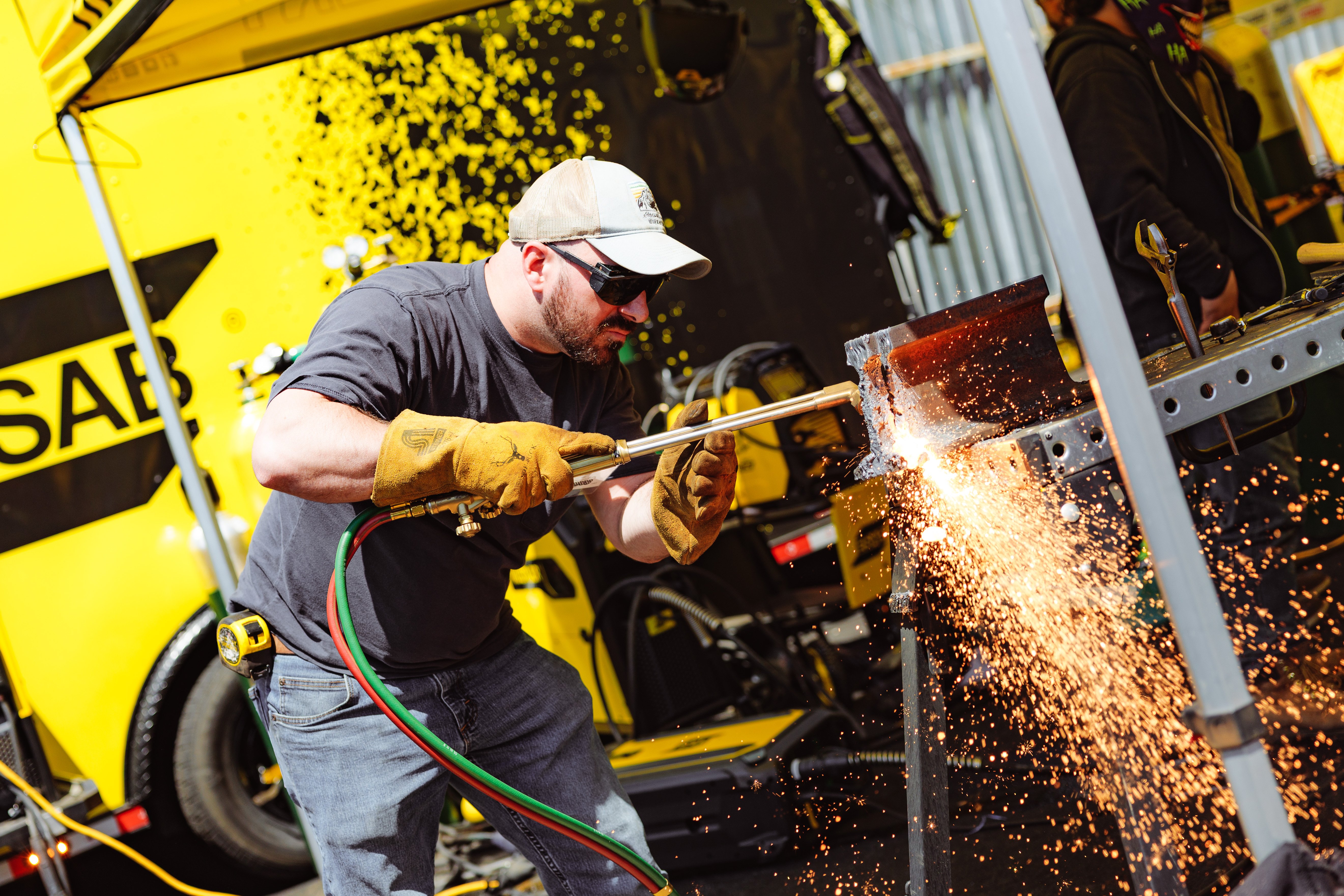 Welder in action at ESAB Demo Tour, showcasing live welding demos with sparks flying, highlighting skilled welders at work.
